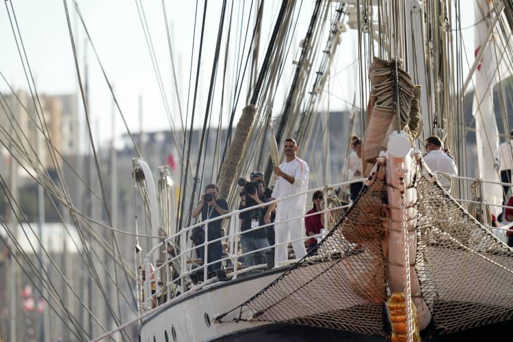 First torch bearer and French Olympic swimmer Florent Manaudou holds the Olympic torch aboard The Belem, the three-masted sailing ship in the old port of Marseille, southern France, May 8. First torch bearer and French Olympic swimmer Florent Manaudou holds the Olympic torch aboard The Belem, the three-masted sailing ship in the old port of Marseille, southern France, May 8.