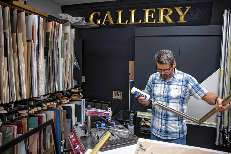 Scott Walton puts together a frame at their custom framing Rowland Studio on Fort Eddy Road in Concord on Tuesday, September 24, 2024.