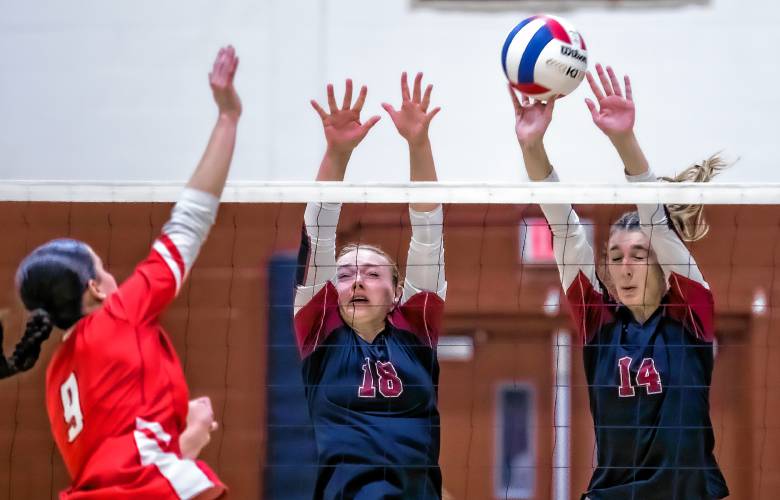 Concord’s Tess Bolduc (18) and Avery MacDonald go up to block a spike.