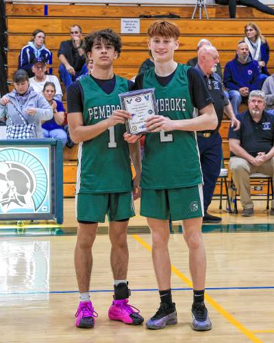 Pembroke Academy boys’ basketball captains Evan Berkeley (left) and Devin Riel pose with the championship plaque after the Spartans defeated ConVal, 66-47, to win the Capital Classic title on Dec. 30 on their home floor. Berkeley was named Tournament MVP.