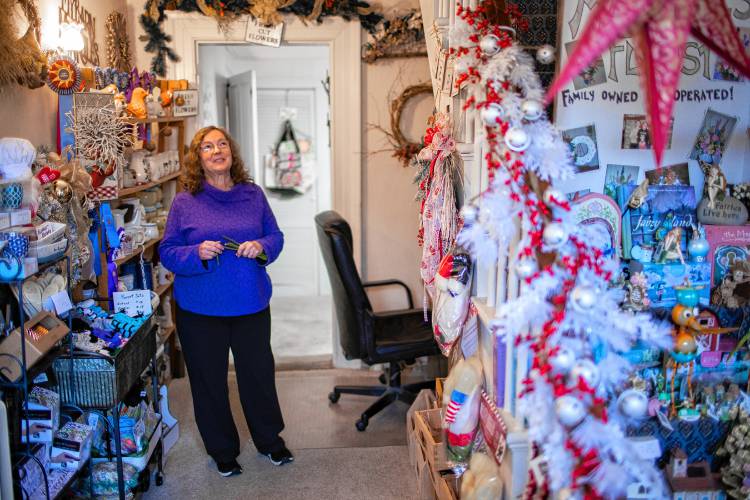 Lorrie Carey, owner and operator of Marshall’s Florist in Boscawen, in the entry way of the store on Thursday, Nov. 16, 2023. The florist will be closing down in the new year.