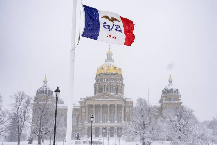 Snow falls at the Iowa State Capitol Building Des Moines, Iowa, Tuesday, Jan. 9, 2024, as a winter snow storm hits the state. (AP Photo/Andrew Harnik)