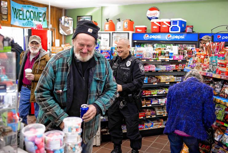 Pittsfield police officer Don Bolduc waits in line at the Bell Brothers convenience store in downtown on Feb. 8.