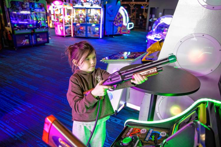 Audrey Lunn, 7, plays at the Smitty’s Cinema arcade area in Tilton on the eve of her birthday with her parents on Wednesday. 