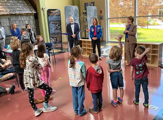 Astronaut Christina Koch, in blue NASA jacket, answers children’s question at the McAuliffe-Shepard Discovery Center on Monday. She stands between U.S. Sen. Jeanne Shaheen and Concord Mayor Byron Champlin.