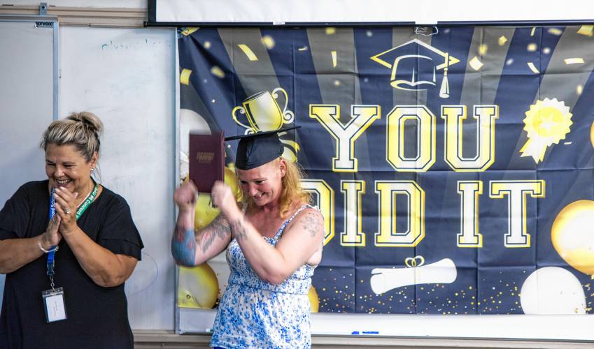 Sara Hodgdon raises her diploma at the Second Start adult graduation celebration as Kelly Dobin of the Second Start Program looks on Thursday evening, June 6, 2024. Hodgdon, a mother of six, told of her trials and tribulations of finally getting her diploma.