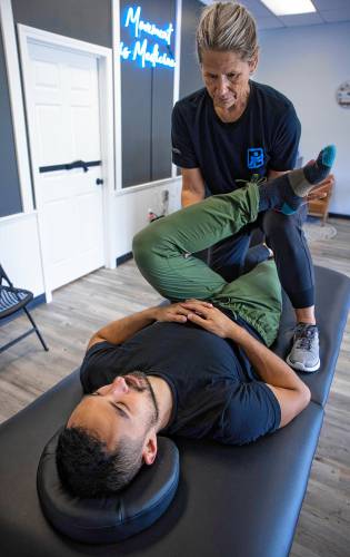 Staff member Karen Kenney works on Mark Marchand on the first day that Flexable Assisted Stretching and Wellness was open on Oct. 1. The new Flexable Studio is at 249 Sheep Davis Road in Concord. They are having an open house on Saturday, Oct. 5.