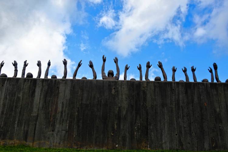 In this April 23, 2018, file photo, is a bronze statue called “Raise Up” that is part of the display at the National Memorial for Peace and Justice in Montgomery, Ala.