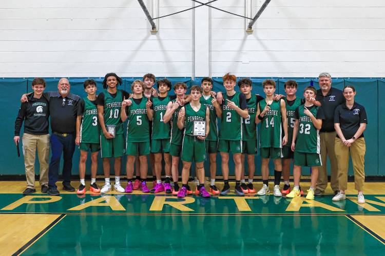 The Pembroke Academy Spartans pose with their championship plaque after winning the Capital Classic on their home floor on Monday night. Pembroke defeated ConVal, 66-47, in the title game.