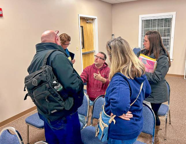 Alicha Kingsbury (right) and other Loudon residents talk with Selectman Dwayne Gilman after the budget public hearing.