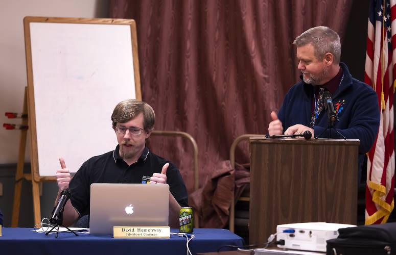 Webster town moderator Mike Jette (right) joins Selectboard Chair David Hemenway in a thumbs up after Hemenway announced to the gathered audience a proposed budget for 2023-24 of 2.29 million, a 0.5% decrease from the current budget on Tuesday night, February 7, 2023. Webster town moderator Mike Jette (right) joins Selectboard Chair David Hemenway in a thumbs up after Hemenway announced to the gathered audience a proposed budget for 2023-24 of 2.29 million, a 0.5% decrease from the current budget on Tuesday night, February 7, 2023.
