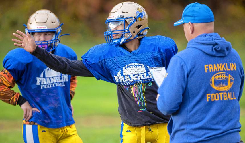 Franklin quarterback Zeke McCoy (center) has had the chance to work with Snow since his coach’s arrival in 2021. “Even if we have bad games, he always finds a positive thing to tell us,” McCoy said. “He pushes us to what we can be and what we can do.”