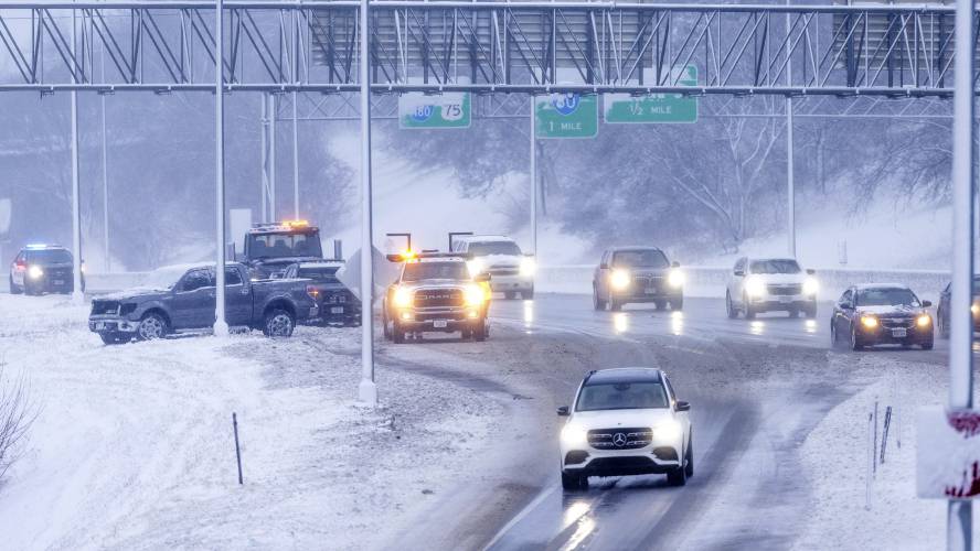 Omaha police and a tow truck respond to an accident on I480 in Omaha, Neb on Tuesday, Jan. 9, 2024 in Omaha, Neb. ( Chris Machian /Omaha World-Herald via AP)