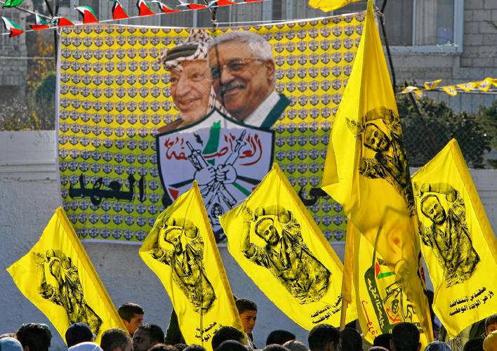 In this Jan. 3, 2008 file photo Palestinian Fatah supporters hold up flags with the picture of the popular Fatah leader jailed in Israel, Marwan Barghouti, as they celebrate at a rally marking the movement's 43rd anniversary in the West Bank city of Ramallah. In this Jan. 3, 2008 file photo Palestinian Fatah supporters hold up flags with the picture of the popular Fatah leader jailed in Israel, Marwan Barghouti, as they celebrate at a rally marking the movement's 43rd anniversary in the West Bank city of Ramallah.
