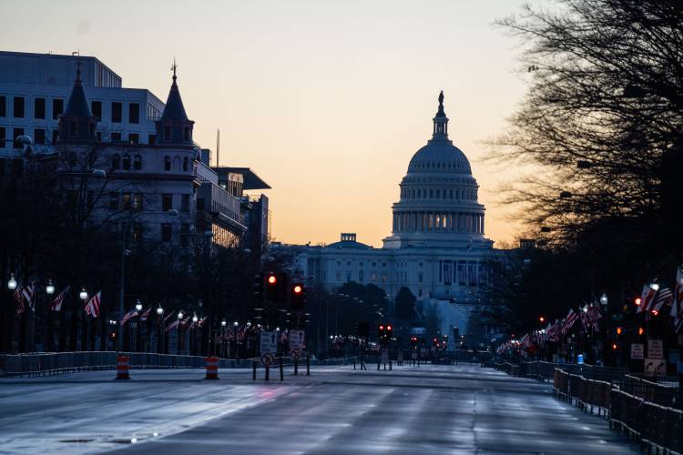 The sun rises behind the U.S. Capitol Building, seen from Pennsylvania Avenue, on Saturday, Jan. 16, 2021. The sun rises behind the U.S. Capitol Building, seen from Pennsylvania Avenue, on Saturday, Jan. 16, 2021.