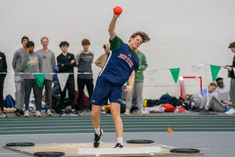 John Stark’s Joel Douzanis throws the shot put at the NHIAA Division II indoor track & field championships on Feb. 11 at Plymouth State. Douzanis won the event with a toss of 47 feet, 2.5 inches, to lead John Stark’s boys’ team to second place, just two points behind champions Coe-Brown.