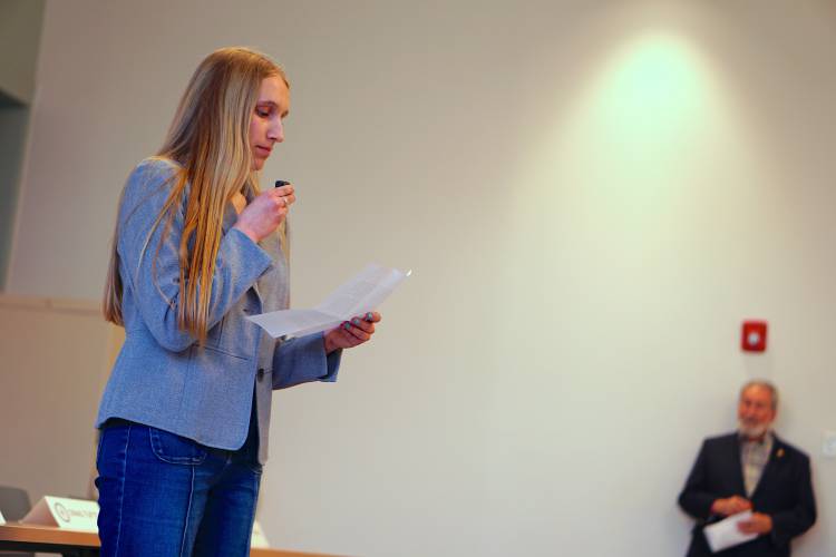 Concord High Senior Myrick Oxnard gives remarks at an Earth Day panel about what sustainability work she’d like to see the city and schools take on in the coming years as Mayor Byron Champlin looks on. 