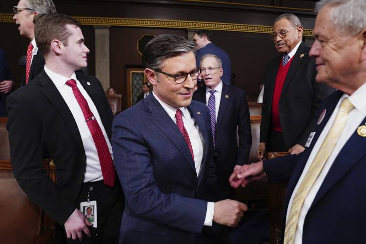 Speaker of the House Mike Johnson, R-La., center, arrives before President Joe Biden delivers the State of the Union address to a joint session of Congress at the Capitol, Thursday, March 7, 2024, in Washington. (Shawn Thew/Pool via AP)