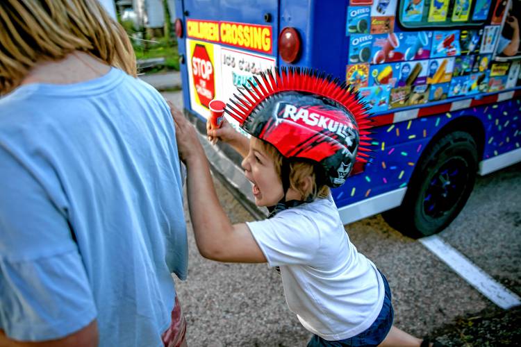 Remy Bowman is excited to get his ice cream on Thursday, August 22, 2024. Bowman came out in the rain to get his cone.