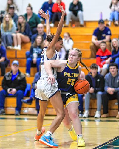 Bow’s Bryanna Szepan (right) looks to pass around Merrimack Valley’s Jada Lucas (left) during the Capital Classic girls’ basketball championship game at Pembroke Academy on Monday. Szepan scored 12 points to help the Falcons claim the Capital Classic title with a 43-41 victory.