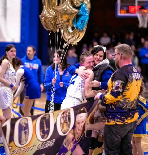 Franklin sophomore Kourtney Kaplan (12) gets a hug after scoring her 1,000th career point on Jan. 13 against Wilton-Lyndeborough at the new Franklin High School gymnasium.