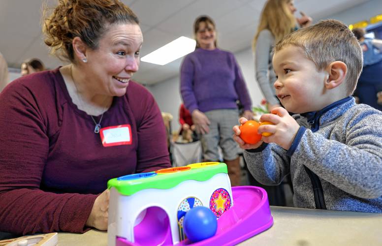 Julie Inglis plays with her son, Kody, at the grand opening of the Concord Family Center on Jennings Drive in Concord on Monday.