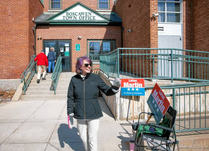 Candidate Loren Martin waves to passerbys outside the Boscawen Town Offices on Tuesday, March 11, 2025. Martin is running for the Board of Selectmen seat currently held by Lorrie Carey. Martin brought gloves for the early morning cold but even at noontime, she still had her gloves on.
