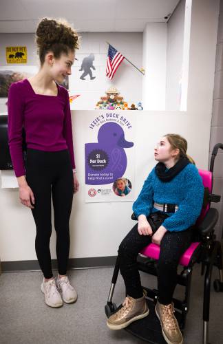 Izzie Boom, right, and her friend Emma Lesperance earlier this month. They were on their way to meet Izzie’s mom at the main office.