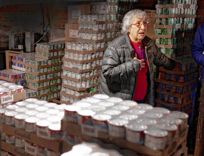 Mary Jane Bailey shows the present Christ the King food pantry where food is brought out of the basement in a small house on the campus of the church on South Main Street in Concord. Bailey started volunteering in the pantry 40 years ago.