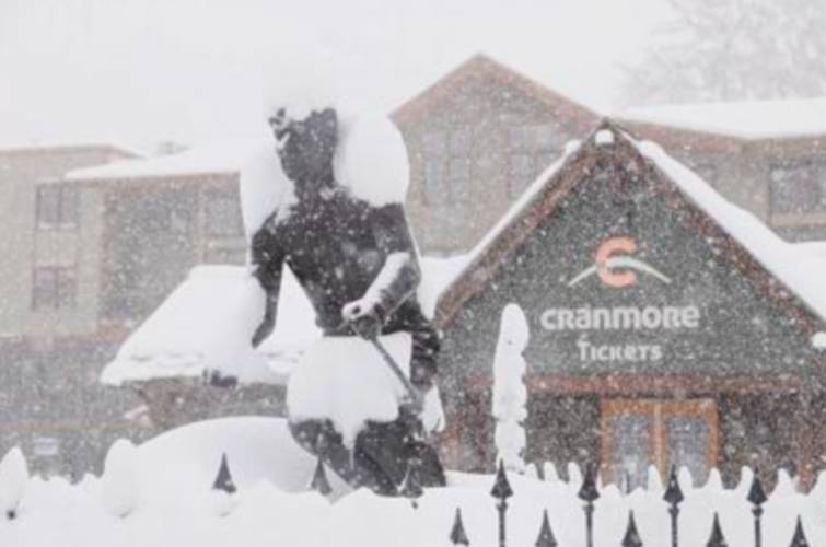Snow flurries around the Hannes Schneider statue at Cranmore Mountain Resort in North Conway during a spring snowstorm on Thursday.