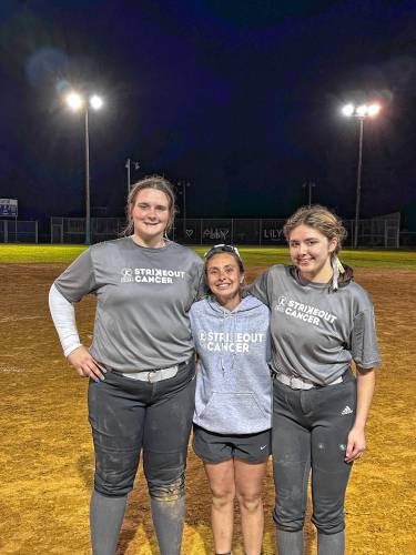 From left: pitcher Lily Cornell, head coach Maddie Trefethen and catcher Ava Kolacz after Cornell picked up her 500th career strikeout on Thursday.