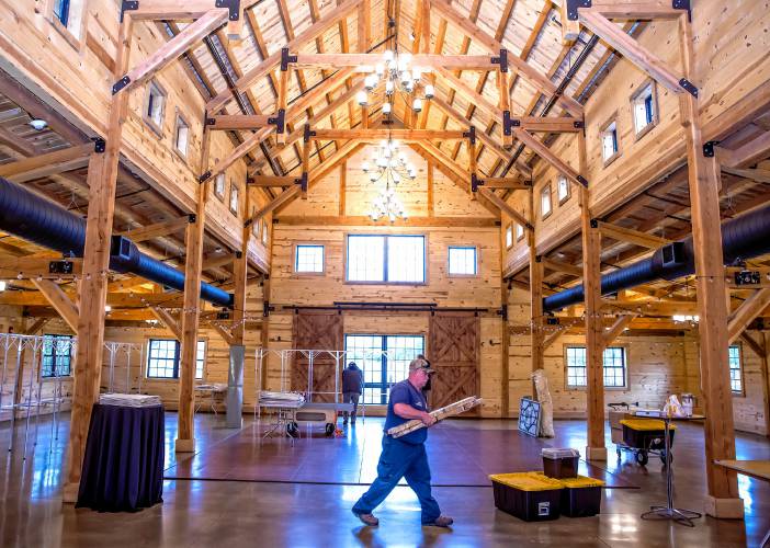 Concord Public Properties crew member Mike Pickering sets up inside The Barn at Bull Meadow on Bog Road as the crews prepare for the Ward Two voting place on Monday, November 4, 2024. The polls will be open from 7:00 a.m. until 7:00 p.m. on Election Day.