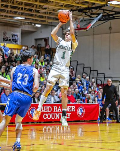 Pembroke’s Evan Berkeley elevates over Pelham’s defenders in Pembroke’s D-II semifinal win.