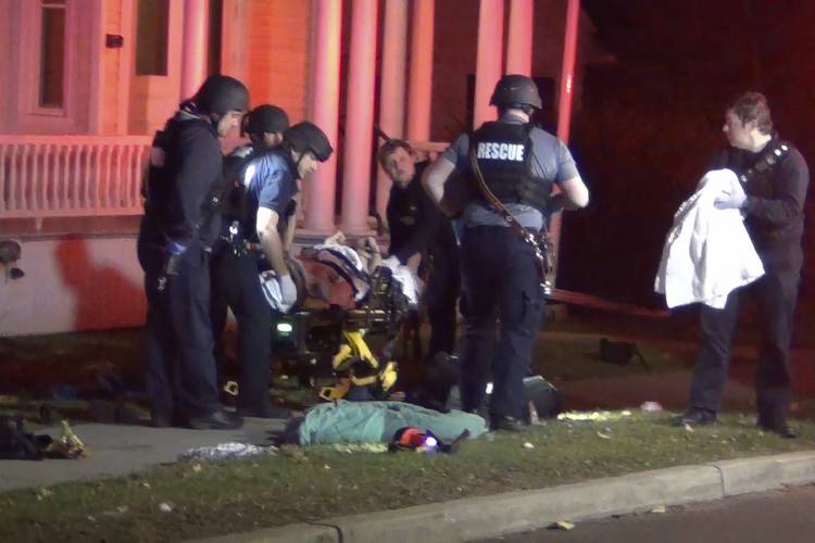 In a still frame from video first responders use a gurney to remove an injured man from the scene of a shooting, Saturday, Nov. 25, 2023, in Burlington, Vt. Burlington Police Department arrested Jason J. Eaton, suspected in the shooting of three young men of Palestinian descent, who were attending a Thanksgiving holiday gathering near the University of Vermont campus Saturday evening. (Wayne Savage via AP)