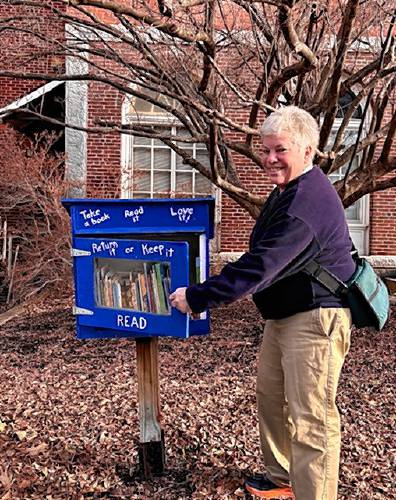 Ann Harrison at the Little Free Library on Grove Street in Peterborough.