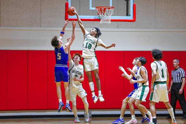 Pembroke junior forward Javien Sinclair (10) blocks a shot by Pelham junior forward Brady Hegan (5) in the second quarter.