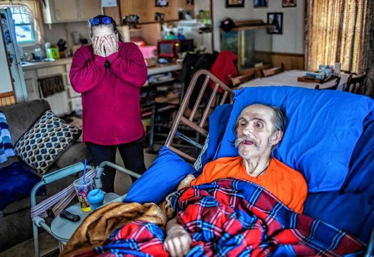 John Jones lies in the hospital bed in the living room of his Franklin house as his partner, Jessica Helfenstein, worries about their future this past January. At that point, Jones and Helfenstein were working to reclaim their home after the city took ownership for unpaid taxes.