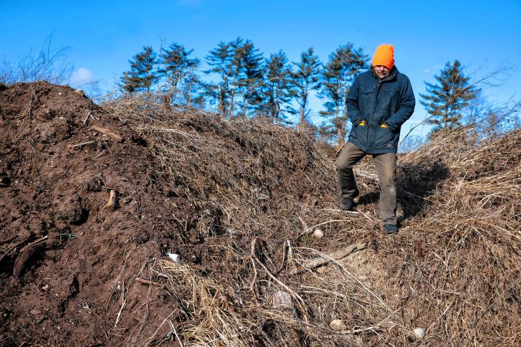 James Meinecke walks on a large mound at Lewis Fam in Concord. Starting Feb. 1, James Meinecke and Rebecca McWilliams’ farm can accept food waste after New Hampshire’s new statewide food waste ban goes into effect. Lewis Farm is gearing up to handle an influx of commercial food scraps.