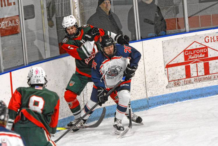 Belmont-Gilford's Ben Girard (26) fights for possession of the puck along the boards during a hockey game at Merrill Fay Arena in Laconia on Saturday, Jan. 11, 2025. Girard scored in the 2-1 victory. JOSHUA SPAULDING / Salmon Press