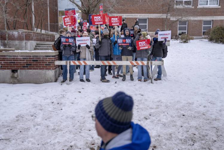 Supporters of Republican presidential candidate former UN Ambassador Nikki Haley cheer as voters enter a polling site to cast their ballots in the New Hampshire presidential primary in Manchester, N.H., Tuesday, Jan. 23, 2024. (AP Photo/David Goldman)