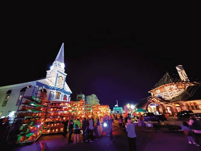 The New Hampshire Pumpkin Festival expanded its footprint in 2023, closing off Veterans Square. Pictured, a rampart of jack-o’-lanterns sets the square, which DJ Spiezio had temporarily transformed into a dance floor, aflame.