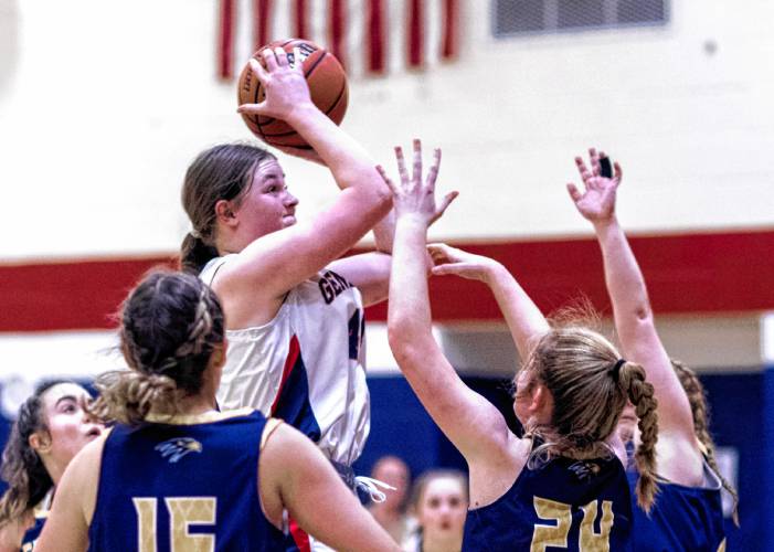 John Stark center Eleanor Girardet scores and gets fouled as she is surrounded by Bow players during the second half on Thursday night.