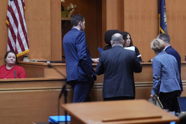 Judge Amy Messer, seated at right, listens to defense and prosecution attorneys as witness Rebecca Maines, left, waits on the witness stand during the trial of the Adam Montgomery at Hillsborough County Superior Court, Tuesday, Feb. 20, 2024, in Manchester, N.H. Montgomery is facing second-degree murder and other charges in the death of his daughter, Harmony. (AP Photo/Charles Krupa, Pool)