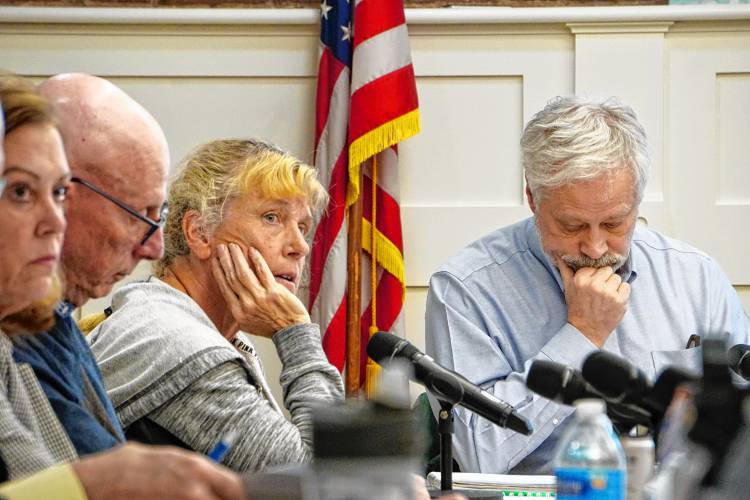  Longtime board member Barbara Higgins, center, was the lone dissenting vote on the budget Wednesday night, citing her opposition to the number of teaching reductions.