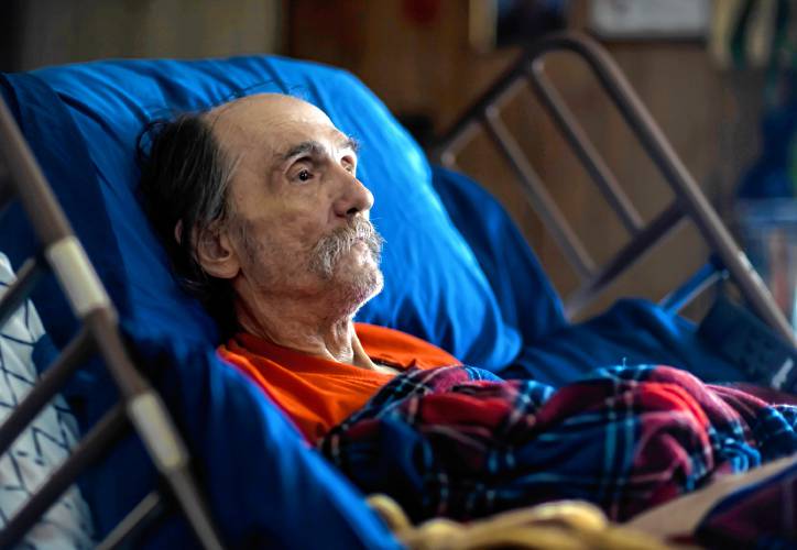 John Jones lies in the hospital bed in the living room of his Franklin house on January 16, 2024. Jones could hardly move is left arm and was confined to bed most of the time.