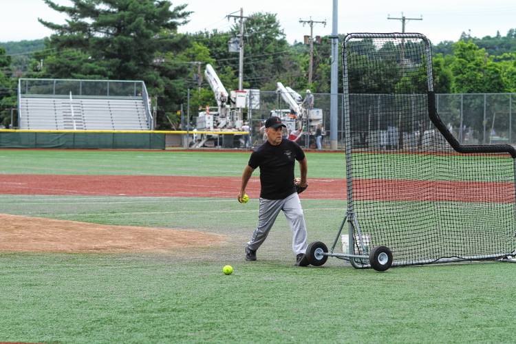 Maine Game Warden Chris Simmons tosses batting practice before the North Woods Throwdown softball game against the New Hampshire Conservation Officers at Gill Stadium on Saturday, June 29, 2024.