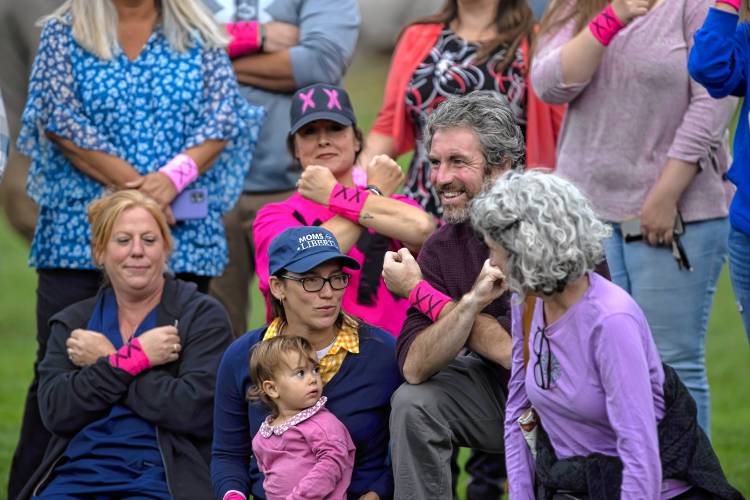 Terese Bastarache (left), joins Jodi Underwood, Rachel Goldsmith, Jeremy Kauffman and Stacey Messina in a display of showing the XX chromosome at the Bow girls soccer game on Tuesday, Sept. 24, 2024.