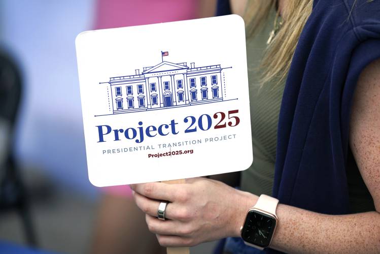 Kristen Eichamer holds a Project 2025 fan in the group’s tent at the Iowa State Fair, Aug. 14, 2023, in Des Moines, Iowa. Kristen Eichamer holds a Project 2025 fan in the group’s tent at the Iowa State Fair, Aug. 14, 2023, in Des Moines, Iowa.