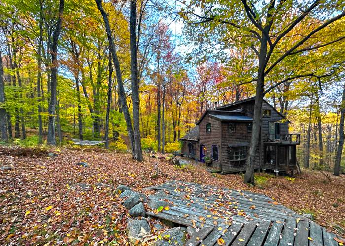 Kate Schimke’s and Aaron Derman’s cabin on the Brookwood Land Trust, with the stage in the foreground. 