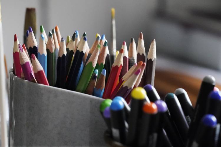 Colored pencils, sharpened and at the ready, rest in a container on the desk of artist Robert Seaman in his room at an assisted living facility Monday, May 10, 2021, in Westmoreland, N.H. Seaman, who moved into the facility weeks before the COVID-19 pandemic shutdown his outside world in 2020, recently completed his 365th daily sketch, or what he calls his 